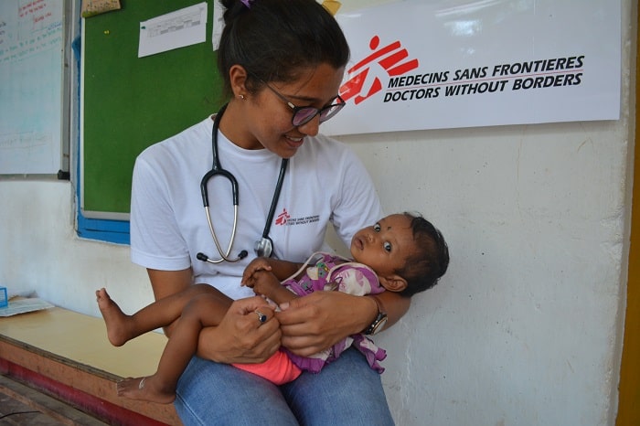 MSF doctor Sahithi with an infant who was diagnosed with pneumonia. According to doctors, the improper breastfeeding practice led to pneumonia